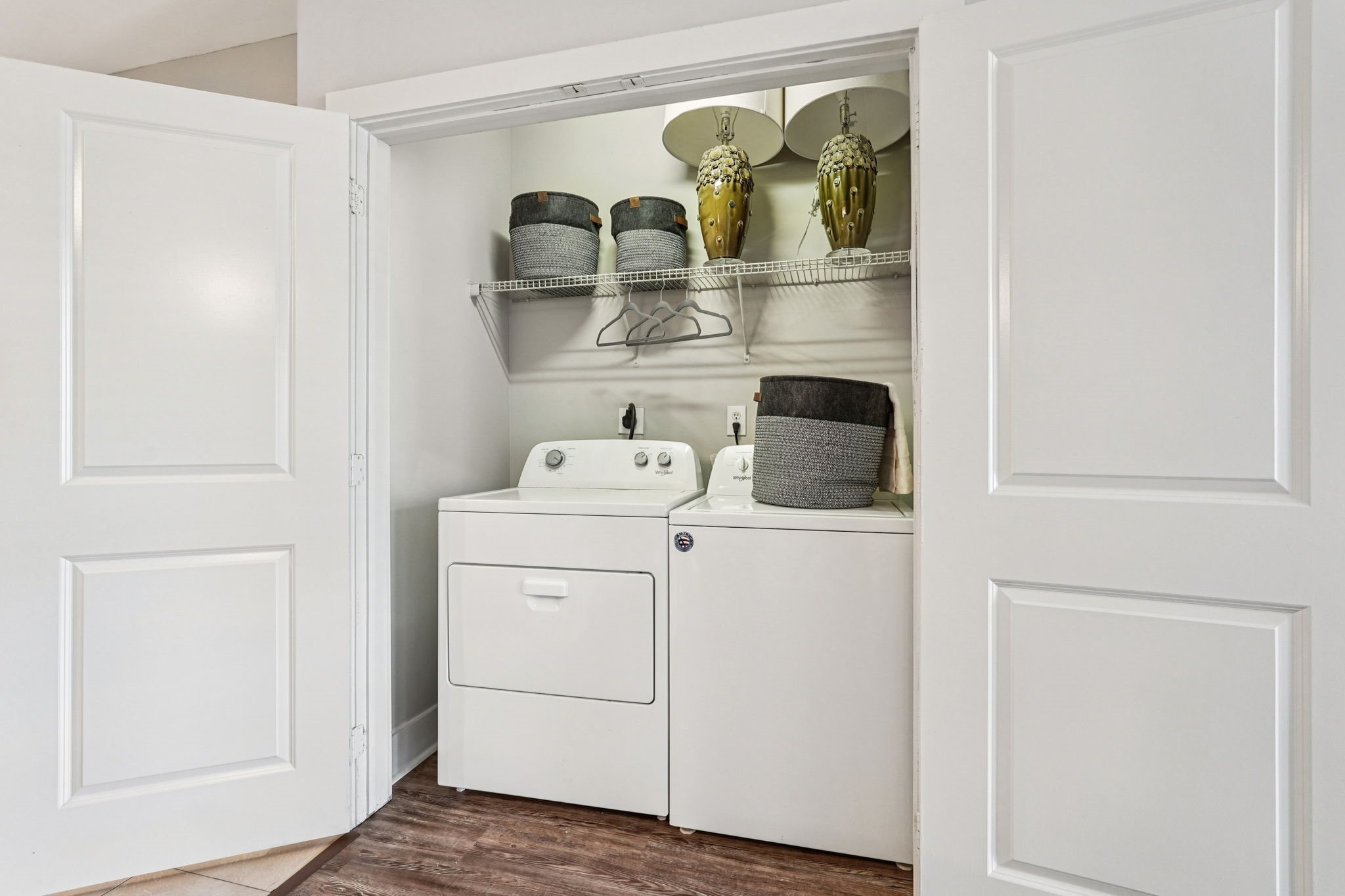 A white bathroom cabinet with a sink and a cabinet door open.